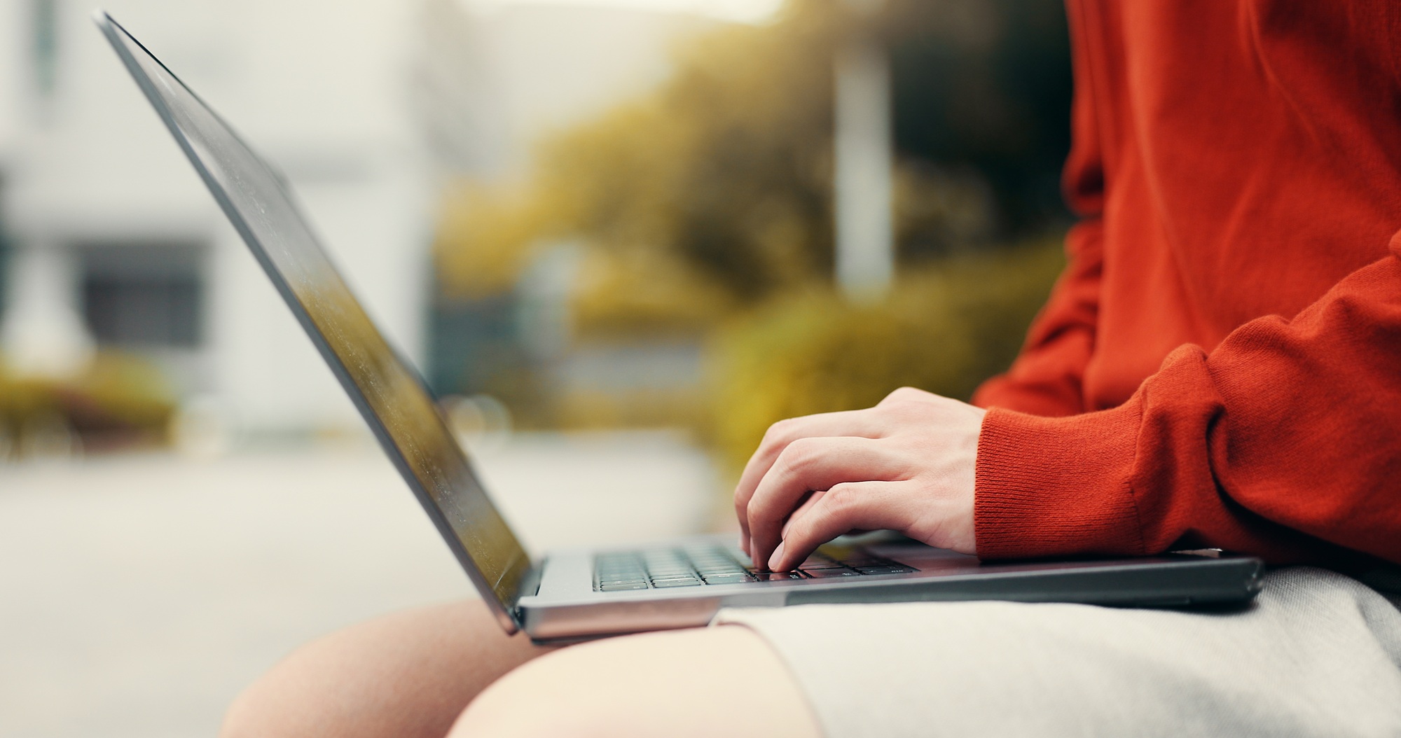 Man hands, laptop or typing in city for studying, planning or creative writing for travel blog in J