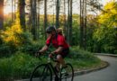 Senior man cycling with his puppy