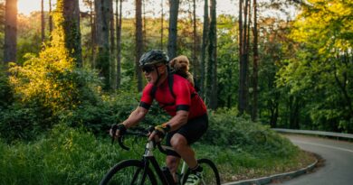 Senior man cycling with his puppy