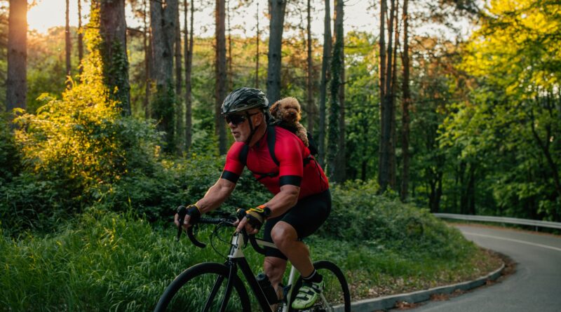 Senior man cycling with his puppy