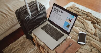 Laptop screen, travel website and suitcase background for vacation planning, hospitality marketing
